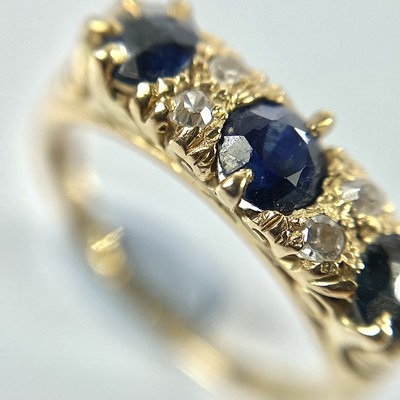 Lot 16 - An early 20th century 18ct diamond and sapphire seven stone ring