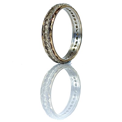 Lot 199 - A 9ct bi-colour white stone set eternity ring,...