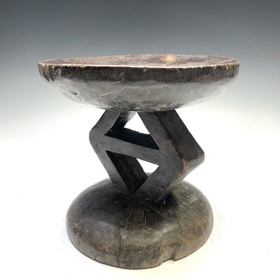 Lot 143 - An African Batong type stool the central...