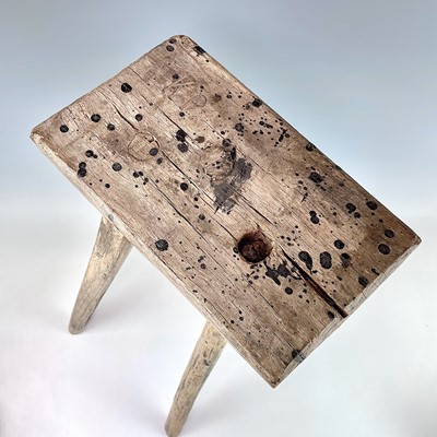 Lot 94 - A primitive three-legged stool, 19th century,...