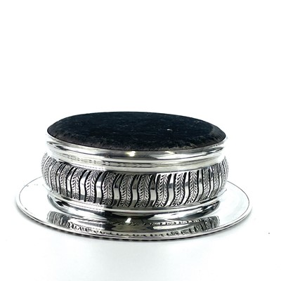 Lot 47 - A modern silver wine coaster by Harrods, with...