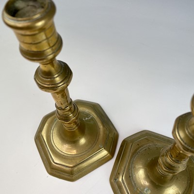 Lot 29 - A pair of Georgian brass candlesticks, with...