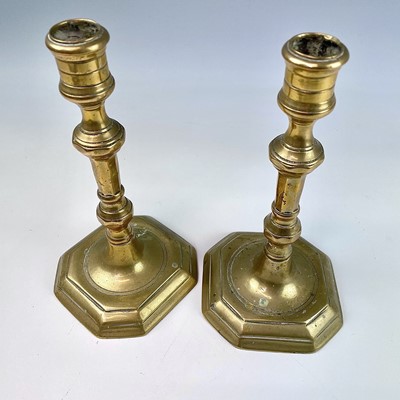 Lot 29 - A pair of Georgian brass candlesticks, with...