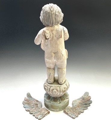 Lot 113 - A painted carved wood figure of a winged...