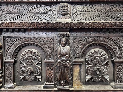 Lot 120 - A carved oak bedhead, early 17th century, with...
