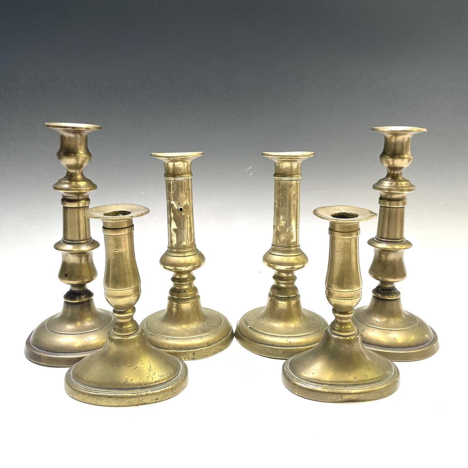 Lot 58 - Three pairs of Georgian brass candlesticks,...