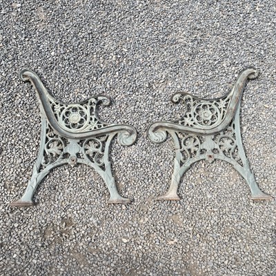 Lot 600 - A pair of Victorian cast iron bench ends, with...