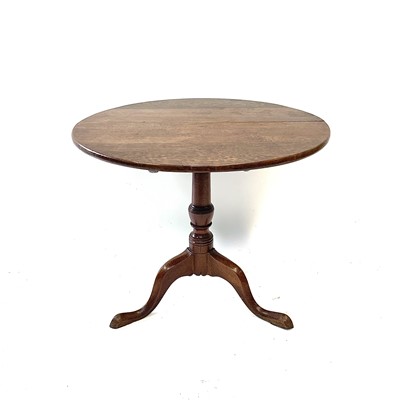 Lot 130 - A George III oak snap top tripod table, the...