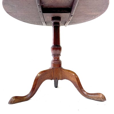 Lot 130 - A George III oak snap top tripod table, the...