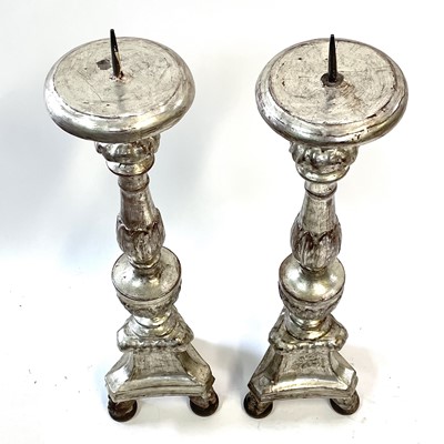 Lot 22 - A pair of Italian silvered carved wood candle stands, circa 1700-1750.