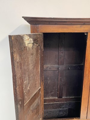 Lot 78 - A George III oak press cupboard, with a pair...