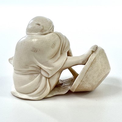 Lot 258 - A Japanese Meiji period carved ivory okimono...
