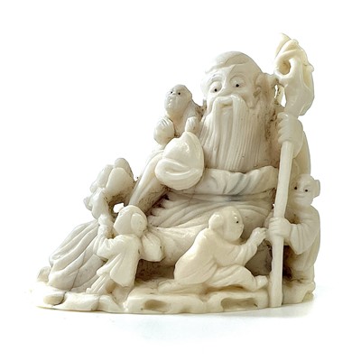 Lot 212 - A Japanese Meiji period carved ivory okimono...