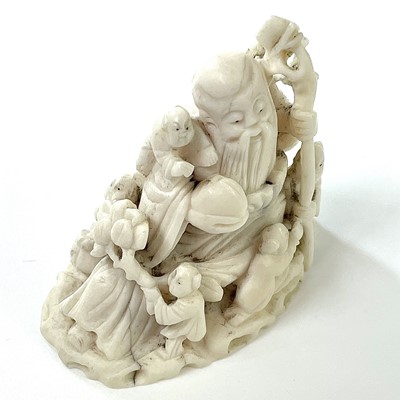 Lot 212 - A Japanese Meiji period carved ivory okimono...