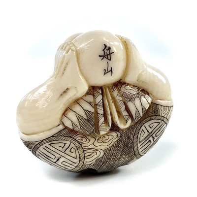 Lot 271 - A Japanese Meiji period carved ivory netsuke...