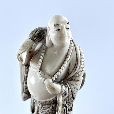 Lot 220 - A Japanese Meiji period carved ivory netsuke...