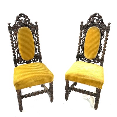 Lot 138 - Two Victorian carved oak hall chairs, the top...