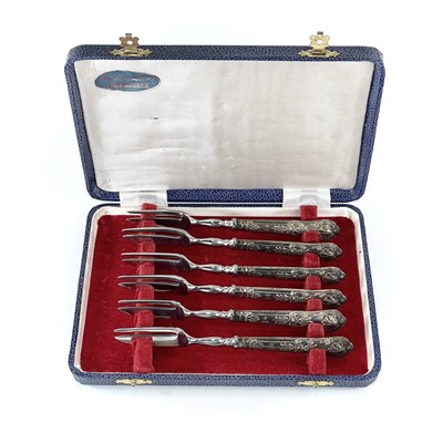 Lot 58 - A cased set of six cake forks with silver...