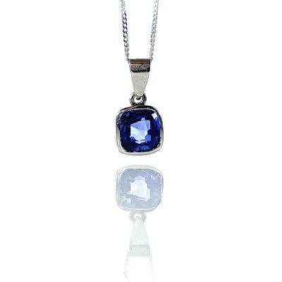 Lot 51 - A platinum sapphire set pendant, the square...
