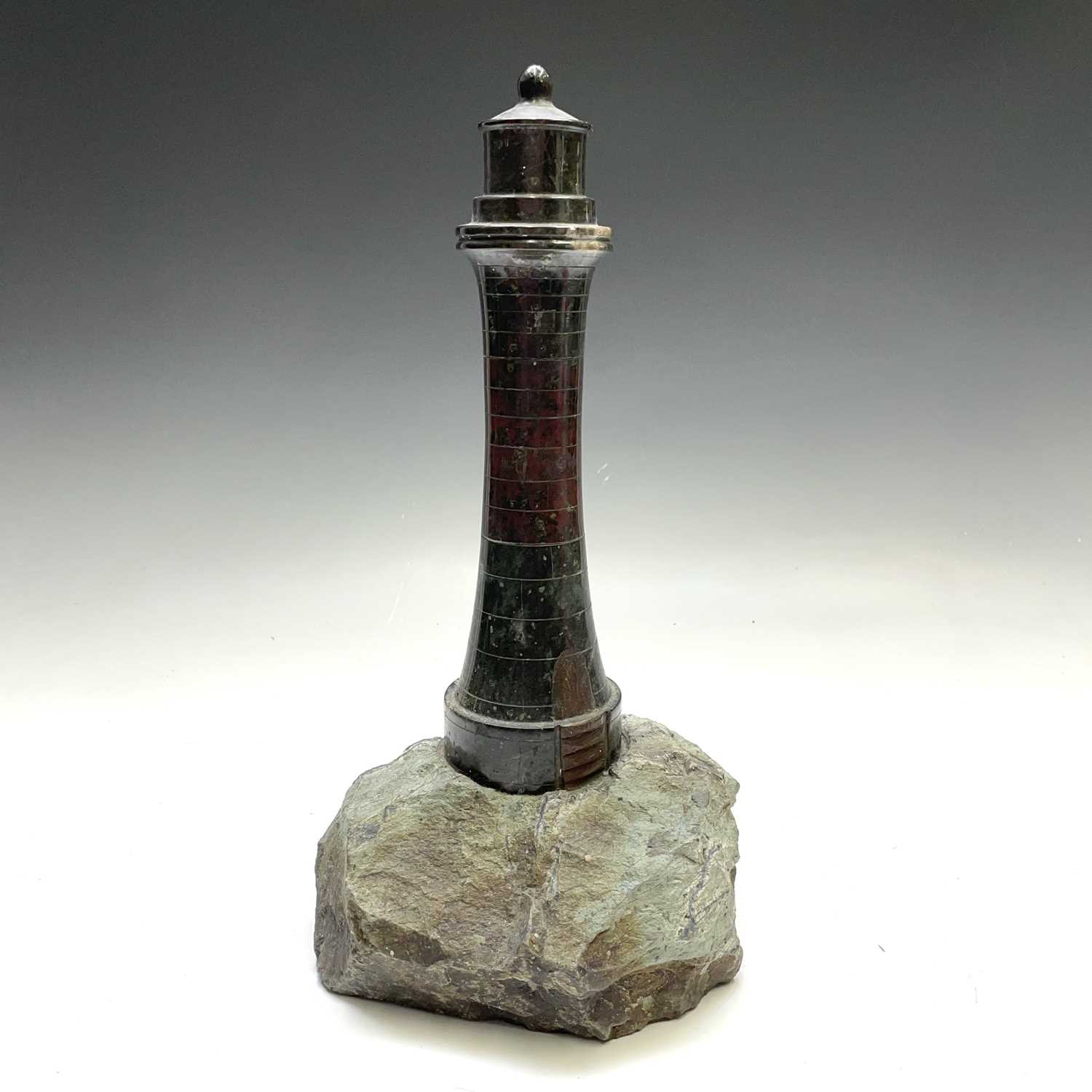 Lot 81 - A Cornish serpentine model of a lighthouse, on...