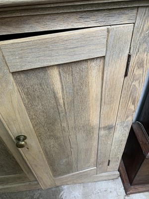Lot 164 - A large ash cupboard, with four panelled doors...