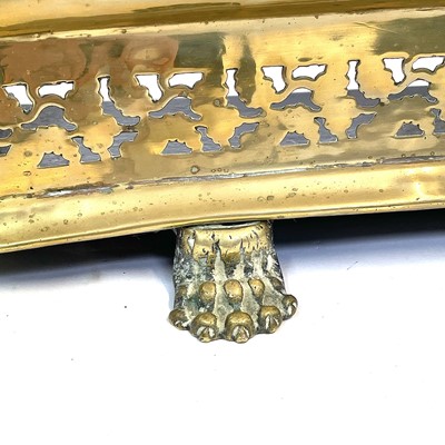 Lot 166 - A George III pierced brass fender, with paw...