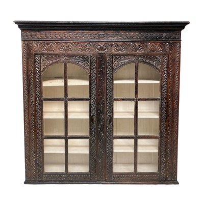 Lot 186 - A 19th century carved oak bookcase, with a...