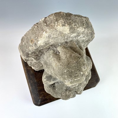 Lot 250 - A medieval carved stone figure, with arms...