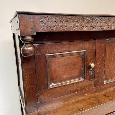 Lot 211 - An 18th century oak court cupboard, dated 1717,...