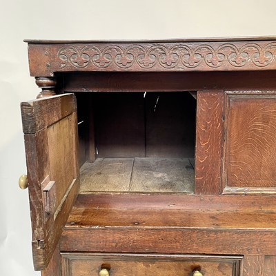 Lot 211 - An 18th century oak court cupboard, dated 1717,...