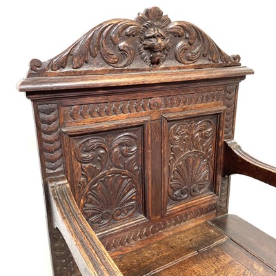 Lot 212 - A Victorian carved oak hall seat, with a...