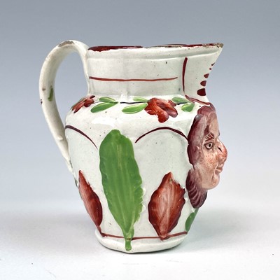 Lot 246 - A small creamware jug, circa 1820, moulded...