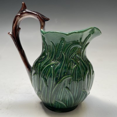 Lot 824 - A small green glazed majolica cream jug,...