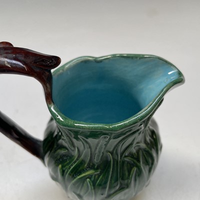 Lot 824 - A small green glazed majolica cream jug,...