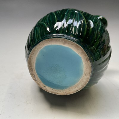 Lot 824 - A small green glazed majolica cream jug,...