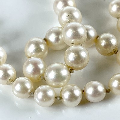 Lot 129 - A graduated pearl necklace with 9ct clasp set...