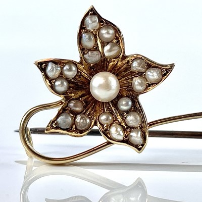 Lot 100 - A 15ct seed pearl set flower brooch, base...
