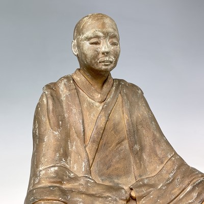 Lot 191 - A painted model of a seated Buddhist monk on a...
