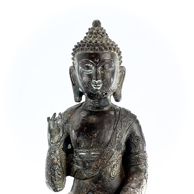 Lot 60 - A Chinese bronze model of a seated buddha,...