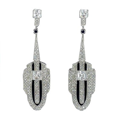 Lot 41 - A pair of Art Deco style white metal white stone set pendant stud earrings.