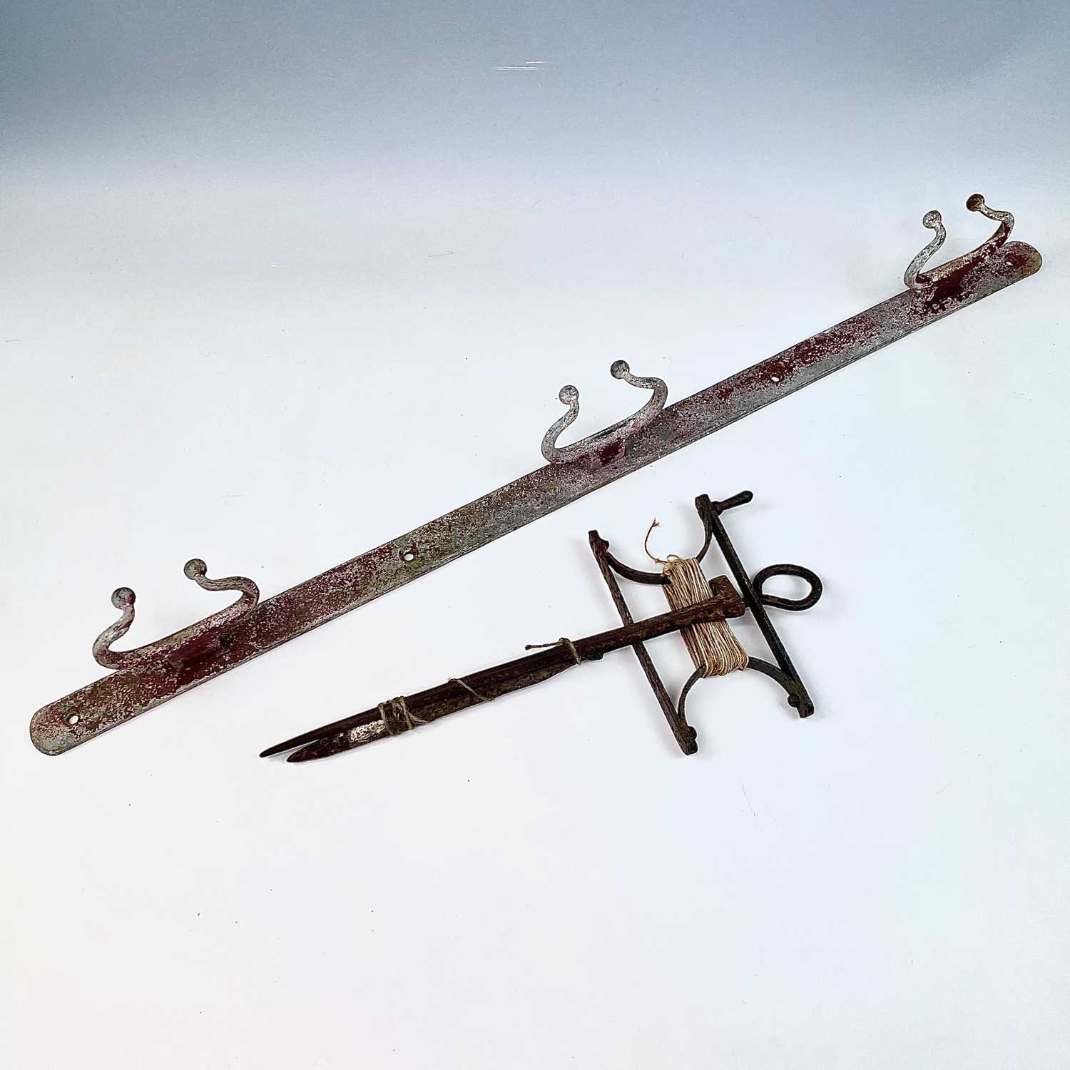 Lot 104 - A wrought iron garden string line and winder,