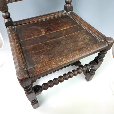 Lot 294 - A 17th century oak backstool, the carved top...