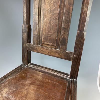 Lot 295 - A 17th Century oak backstool, the arched top...