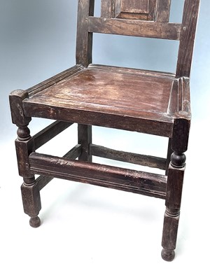 Lot 295 - A 17th Century oak backstool, the arched top...