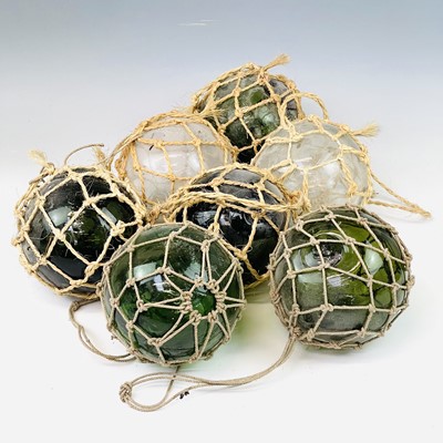 Lot 94 - A collection of glass floats including green...