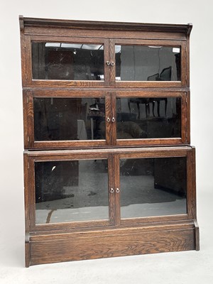 Lot 3020 - An oak sectional bookcase, 1930s, the three...