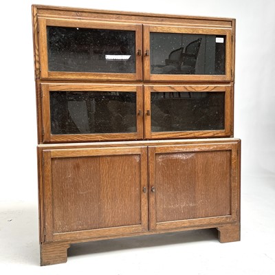 Lot 3021 - An Art Deco oak sectional bookcase, the three...