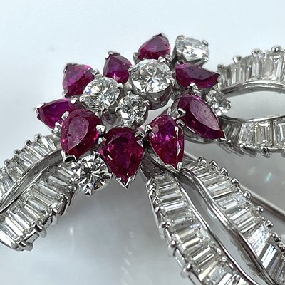 Lot 124 - A stylish mid-century diamond and ruby brooch,...