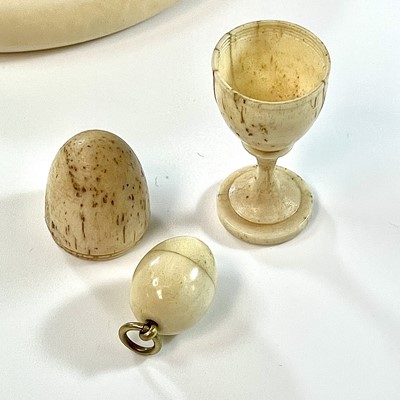 Lot 255 - A Georgian carved bone egg shaped box on stand,...