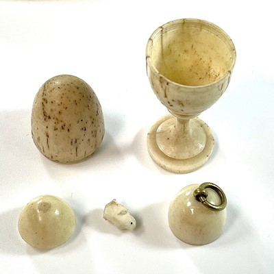 Lot 255 - A Georgian carved bone egg shaped box on stand,...